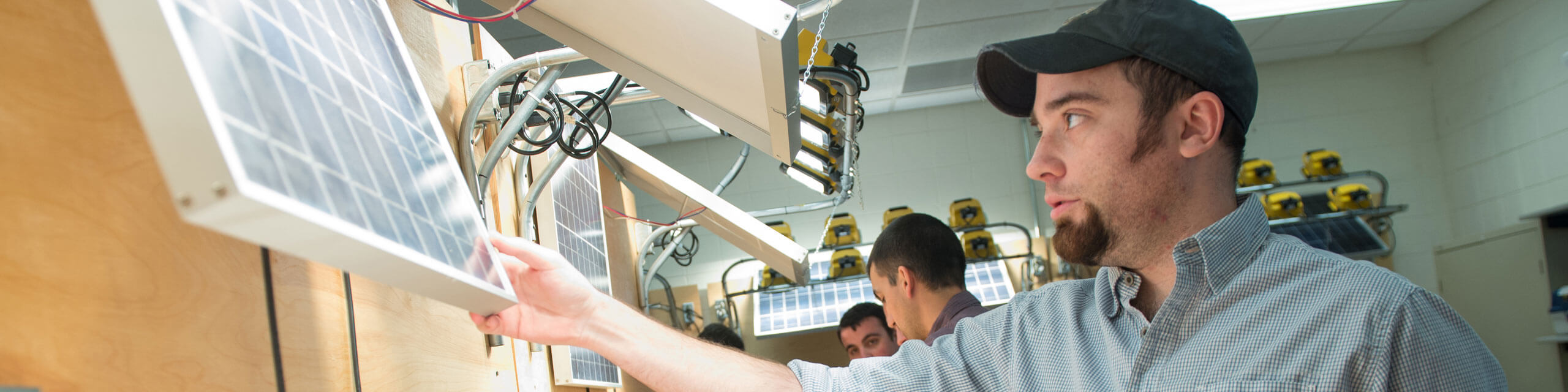 Student works on a solar panel.